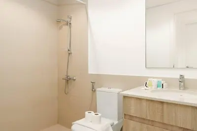 a bathroom with a toilet and a sink and a mirror at Nice 1Bedroom - UNA Townsquare in Dubai