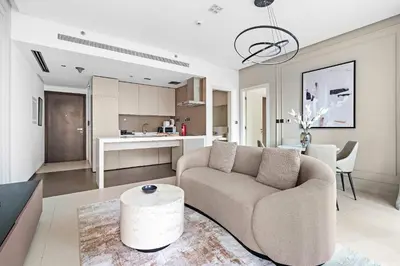 a living room with a couch and a table at Silkhaus chic 1BDR in west avenue with Pool & gym access in Dubai