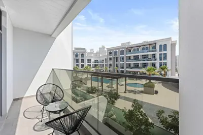 an indoor balcony with chairs and tables and a building at Silkhaus Modern Studio with New Furniture in Dubai