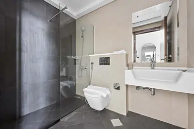 a bathroom with a toilet and a sink and a mirror at Silkhaus Modern Studio with New Furniture in Dubai