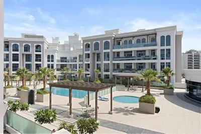 an exterior view of a large building with a pool at Silkhaus Modern Studio with New Furniture in Dubai