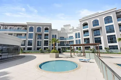 an exterior view of a large building with a pool at Silkhaus Modern Studio with New Furniture in Dubai