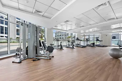 a gym with treadmills and cardio equipment in a building at Silkhaus aesthetic studio in Art Gardens with gym & pool access in Dubai