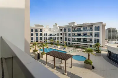 a view of a large building with a swimming pool at Silkhaus aesthetic studio in Art Gardens with gym & pool access in Dubai