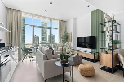a living room with a couch and a tv at Silkhaus modern studio in Liberty House in Dubai