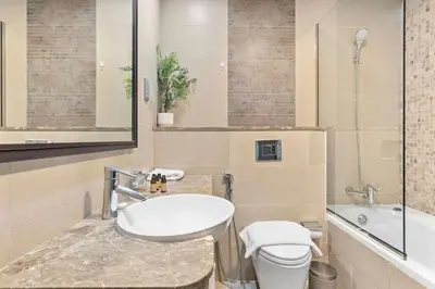 a bathroom with a sink and a toilet and a tub at Silkhaus modern studio in Liberty House in Dubai