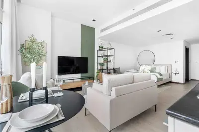 a living room with a white couch and a table at Silkhaus modern studio in Liberty House in Dubai