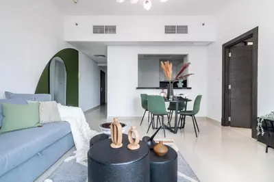 a living room with a couch and a table at The Smart Concierge - Silverene in Dubai