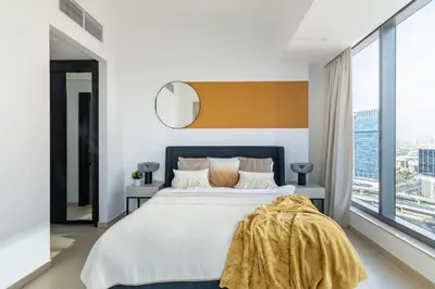 a bedroom with a large bed and a large window at The Smart Concierge - Silverene in Dubai
