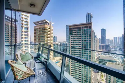 a balcony with a chair and a view of the city at The Smart Concierge - Silverene in Dubai