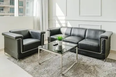 a living room with two leather couches and a coffee table at RH- Urban Living, spacious 01BR, near burj Khalifa in Dubai