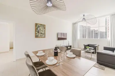a dining room and living room with a table and chairs at RH- Urban Living, spacious 01BR, near burj Khalifa in Dubai