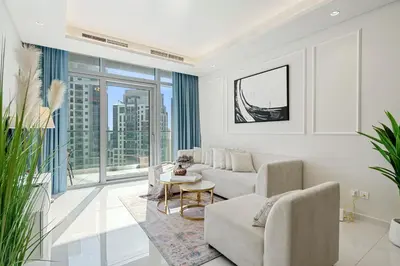 a living room with a couch and a table at Stunning 2BR with Burj Views Infinity Pool in Dubai