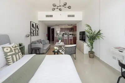 a bedroom with a bed and a living room at Frank Porter - Oasis Tower 1 in Dubai