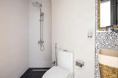 a bathroom with a white toilet and a sink at Frank Porter - Bayz Tower by Danube in Dubai
