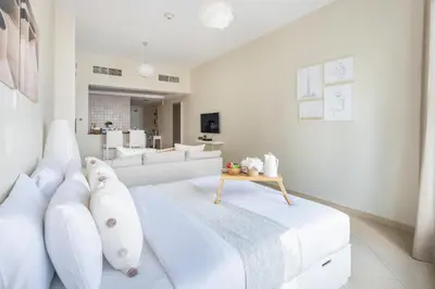 a white living room with a couch and a table at Frank Porter - Concorde Tower in Dubai