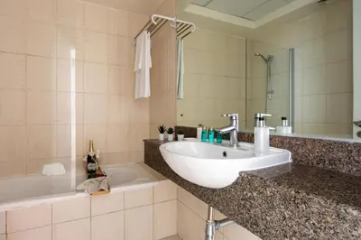 a bathroom with a sink and a bath tub at Frank Porter - Concorde Tower in Dubai