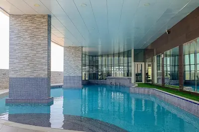 a large swimming pool in a large building at Frank Porter - Concorde Tower in Dubai