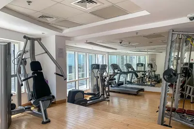 a gym with treadmills and ellipticals in a building at Frank Porter - Concorde Tower in Dubai