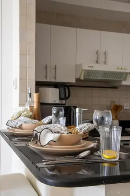 a kitchen counter with plates of food on it at Frank Porter - Concorde Tower in Dubai