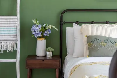 a bedroom with a bed and a vase of flowers on a table at Frank Porter - Blakely Tower in Dubai