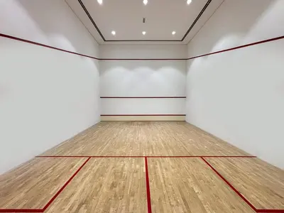 an empty room with a wooden tennis court at Frank Porter - Blakely Tower in Dubai