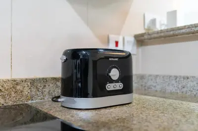 a black toaster sitting on top of a counter at White Sage - Gorgeous Apartment in JLT Near the Metro Station in Dubai