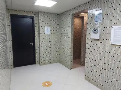 a bathroom with a black door and a tile wall at White Sage - Gorgeous Apartment in JLT Near the Metro Station in Dubai
