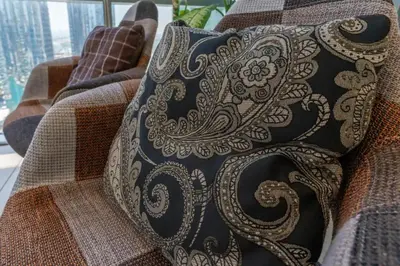 a pillow sitting on the back of a couch at Summer Deal! Stylish 1 BR in Jumeirah Lake Towers in Dubai