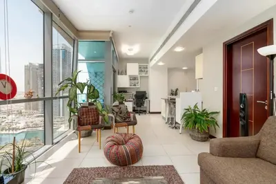 a living room with a couch and some plants at Summer Deal! Stylish 1 BR in Jumeirah Lake Towers in Dubai