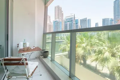 a balcony with a chair and a view of the city at Frank Porter - Panoramic Tower in Dubai