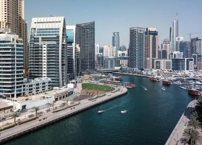 a river in a city with boats in the water at Frank Porter - Panoramic Tower in Dubai