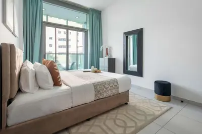 a bedroom with a large bed with a large window at Frank Porter - Panoramic Tower in Dubai