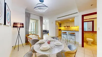 a dining room and kitchen with a table and chairs at Al Murjan - Appealing Two Bedroom in Dubai
