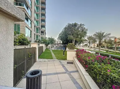 a walkway in a building with flowers and plants at Al Murjan - Appealing Two Bedroom in Dubai