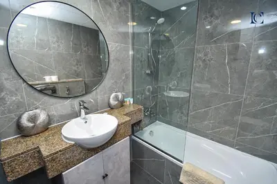 a bathroom with a sink and a mirror at Luxury Escapes - Spacious Studio with Balcony & Marina View - Bay Central in Dubai