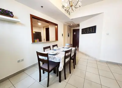 a dining room with a table and chairs at RH- The Perfect Family Getaway, 3BR in Standpoint Tower in Dubai