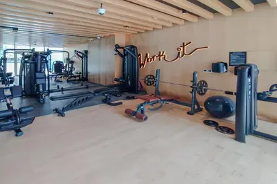 a gym with lots of equipment in a room at Modern Studio with Pool & Gym Access in Dubai