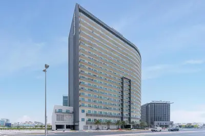 a tall building with a lot of windows at Modern Studio with Pool & Gym Access in Dubai