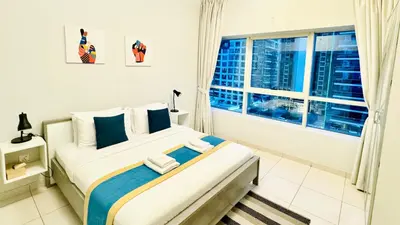 a bedroom with a large bed and a window at Alluring 1BR Opp to JBR Beach- Marina Views in Dubai