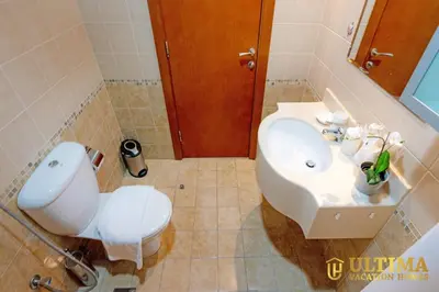 a bathroom with a white toilet and a sink at Alluring 1BR Opp to JBR Beach- Marina Views in Dubai