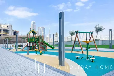 a playground with a slide in a park at LUX The Executive Sobha Suite 2 in Dubai
