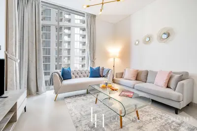 a living room with a couch and a table at LUX The Executive Sobha Suite 2 in Dubai