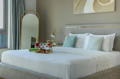 a bedroom with a large white bed with a mirror at Frank Porter - South Ridge 6 in Dubai