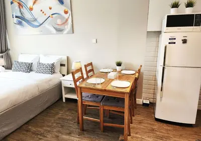 a small kitchen with a table and a refrigerator at RH- Contemporary & Comfortable, Studio near Dubai mall in Dubai