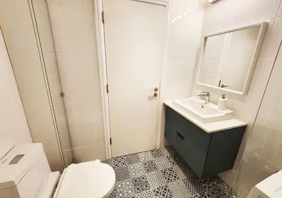 a bathroom with a sink and a toilet and a mirror at RH- Contemporary & Comfortable, Studio near Dubai mall in Dubai