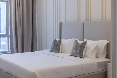 a bedroom with a white bed with pillows and a window at 1BDR Apartment I Close To Metro I Marina Diamond 4 in Dubai