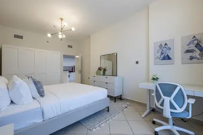 a bedroom with a bed and a desk and a chair at 1BDR Apartment I Close To Metro I Marina Diamond 4 in Dubai
