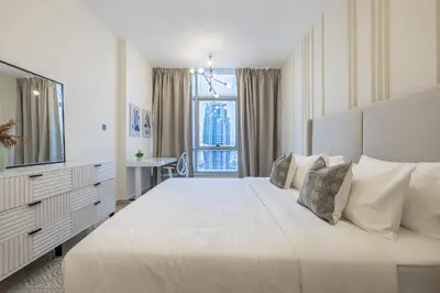 a white bedroom with a large bed and a window at 1BDR Apartment I Close To Metro I Marina Diamond 4 in Dubai