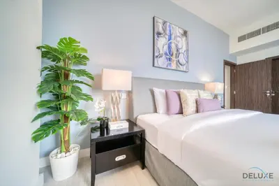 a bedroom with a bed and a potted plant at Exquisite 2BR At Shams 1 JBR by Deluxe Holiday Homes in Dubai